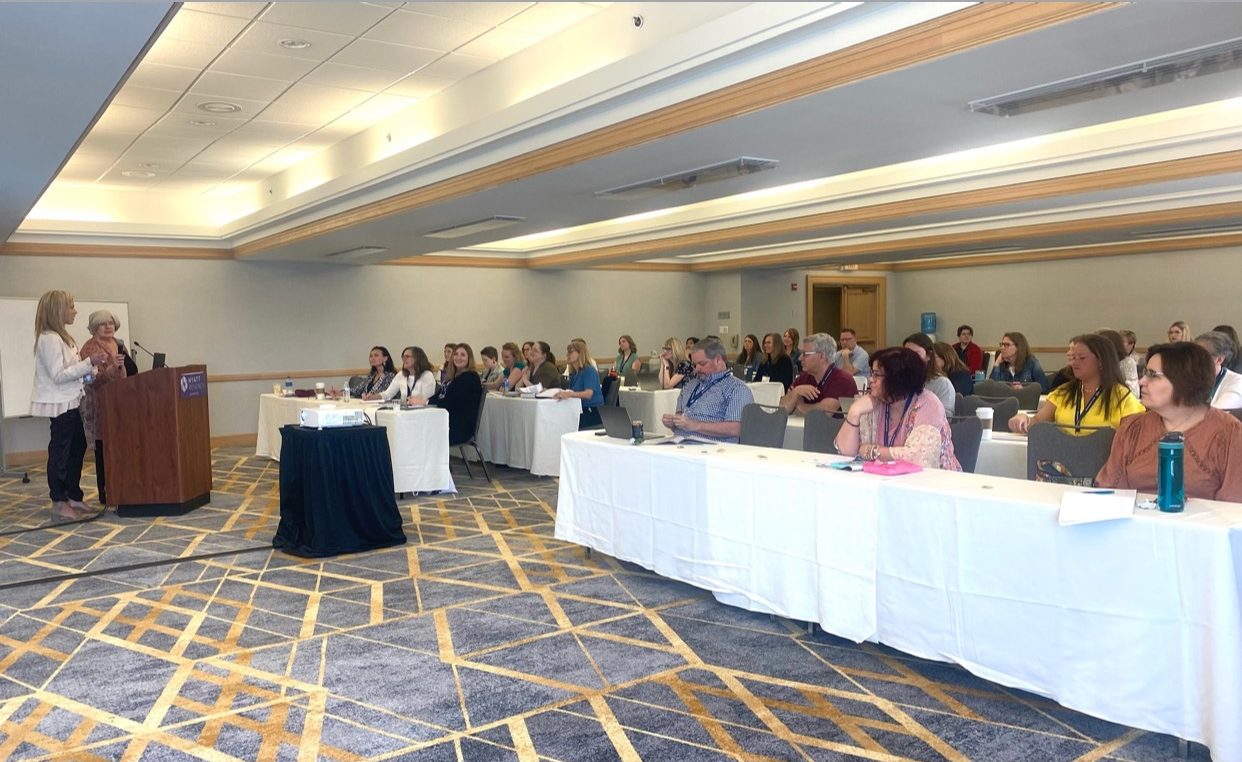 Liliana Grace speaking to a workshop audience