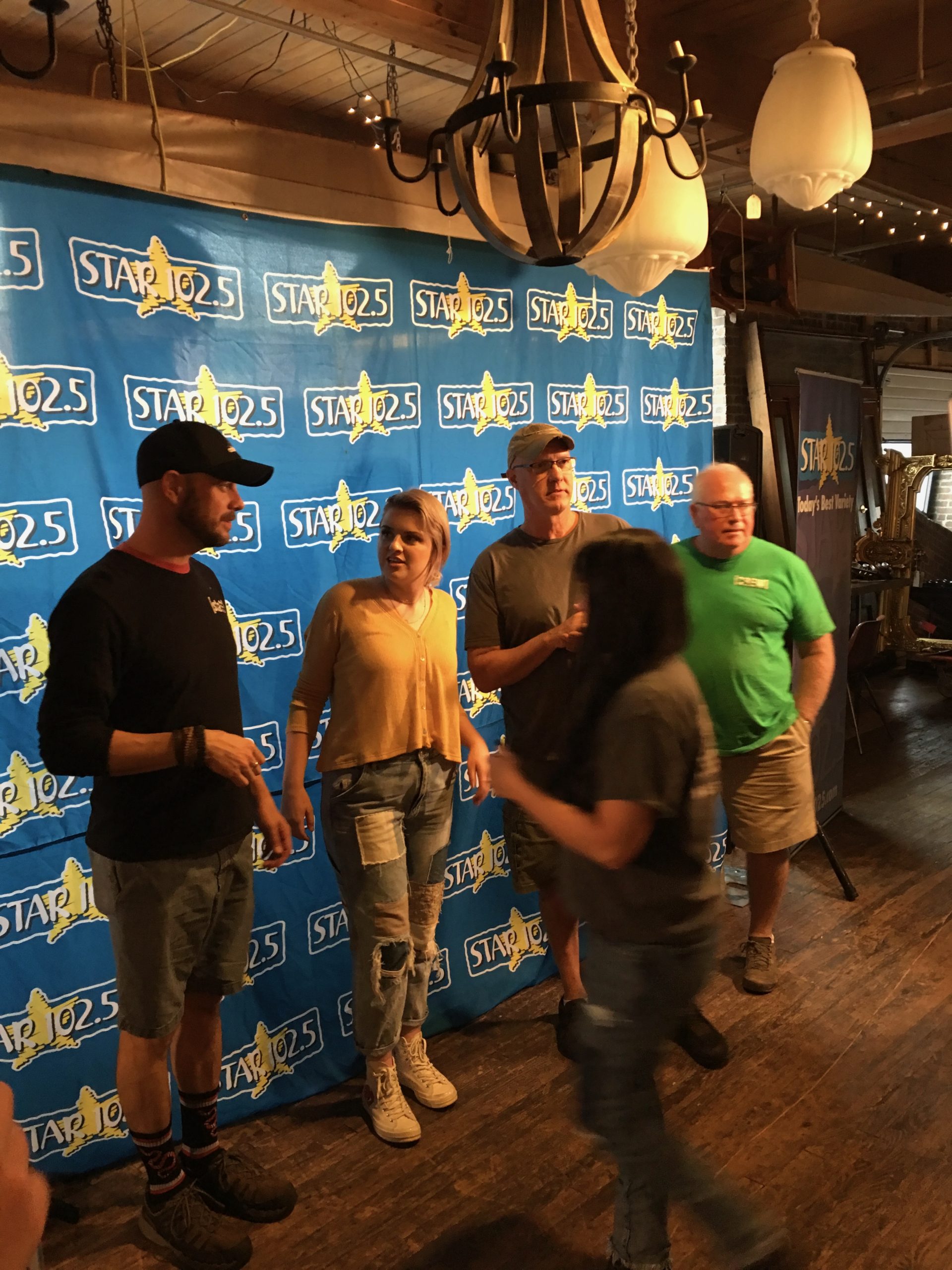 Media team at a Star 102.5 event backdrop