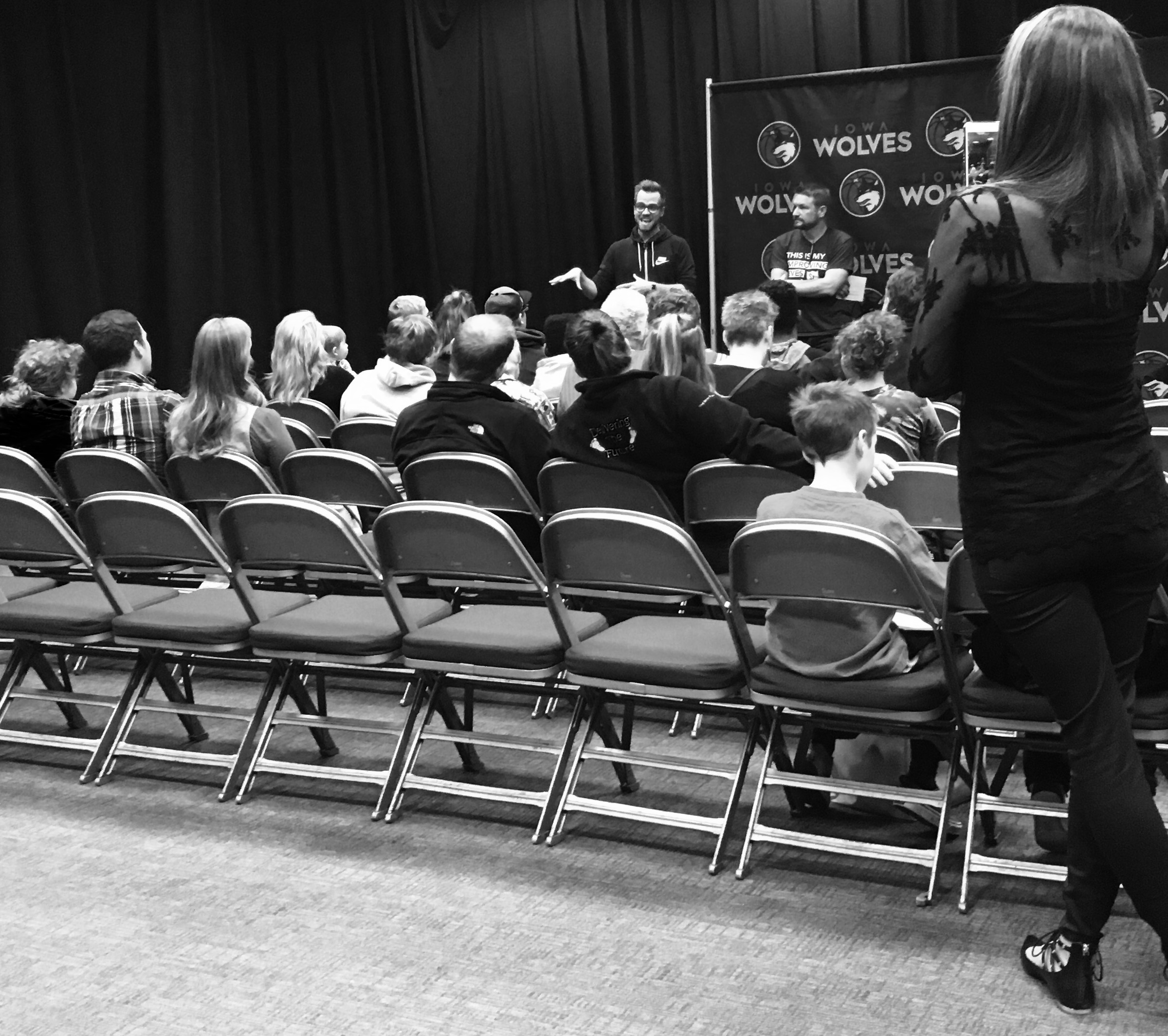 Speakers addressing an Iowa Wolves audience