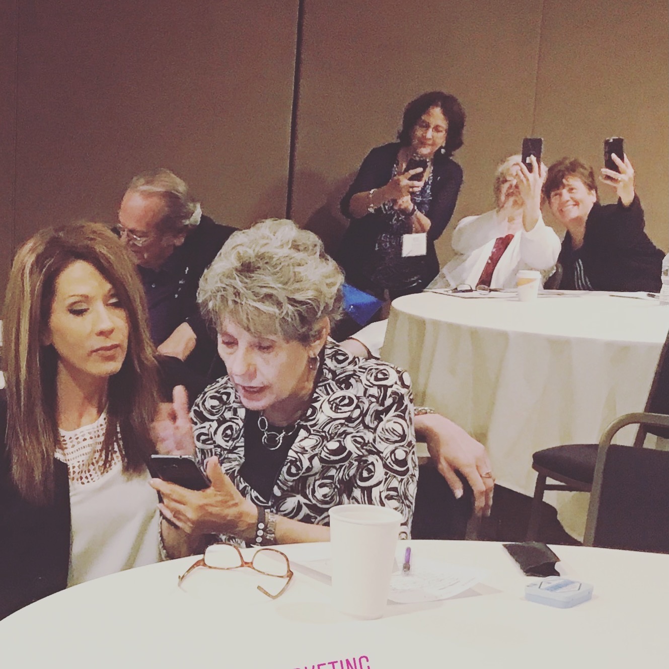 Liliana Grace coaching a participant at a workshop table